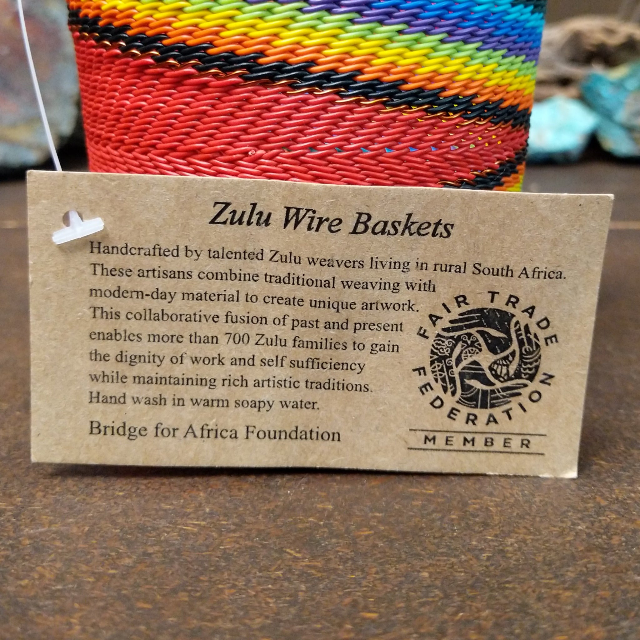 Handwoven multicolor wire art cup by Bridge for Africa featuring vibrant recycled wire in a colorful diagonal pattern, ideal as a decorative container, utensil holder, or pencil cup; artisan information.