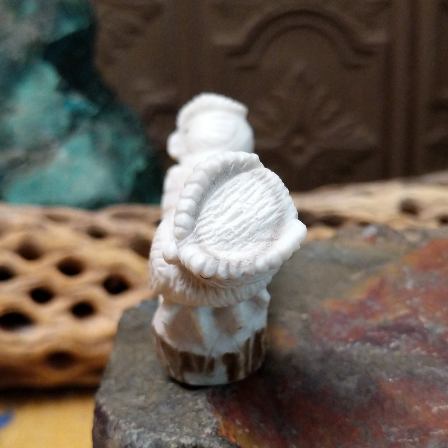 Zuni owl fetish carving by Chris Peina featuring two white stone owls with black inlaid eyes perched back to back on a shared base.