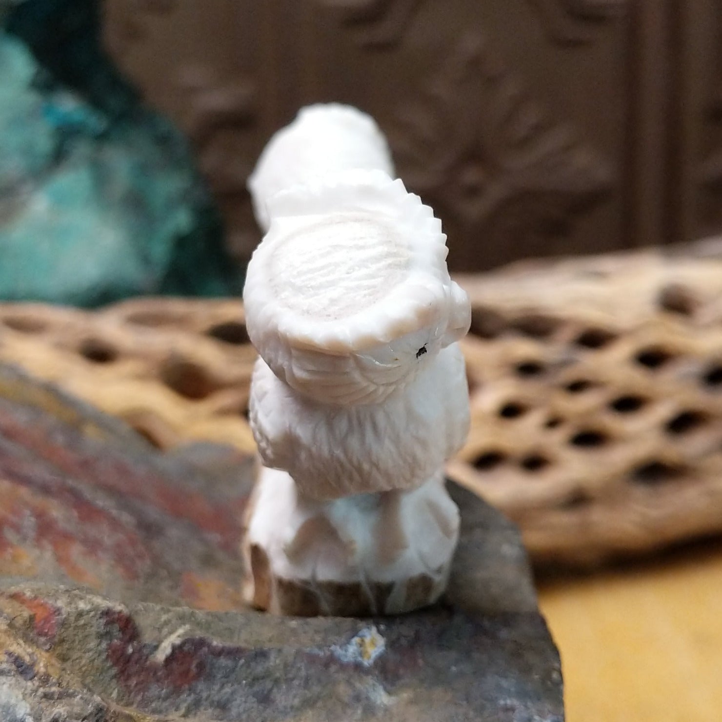 Zuni owl fetish carving by Chris Peina featuring two white stone owls with black inlaid eyes perched back to back on a shared base.