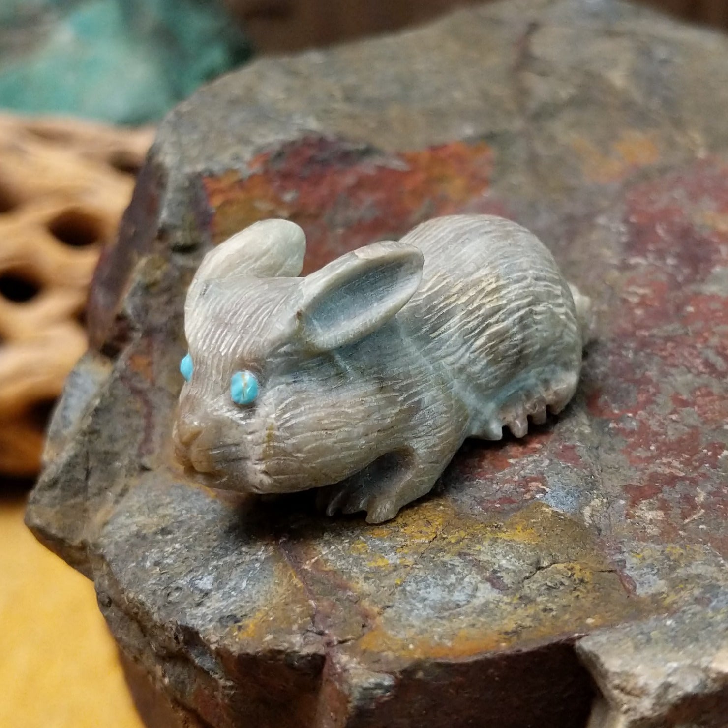 Zuni rabbit fetish carving by Bernie Laselute with carved fur texture and turquoise inlaid eyes.