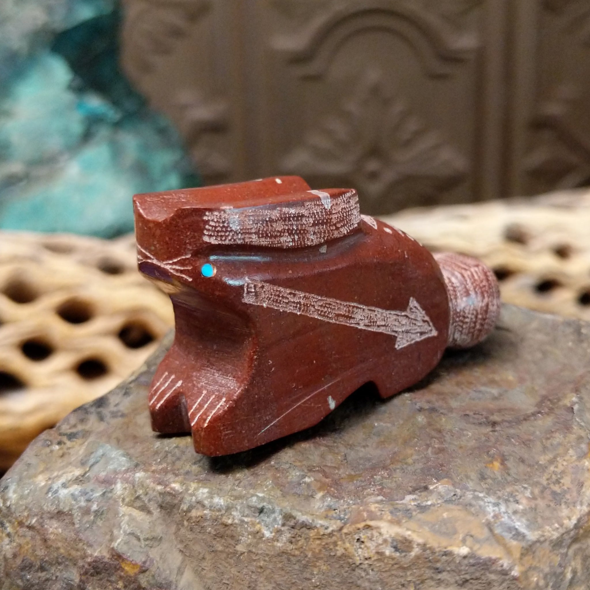 Rabbit Zuni fetish carving by Patrick Wallace in red stone with an engraved arrow motif and turquoise inlaid eye.