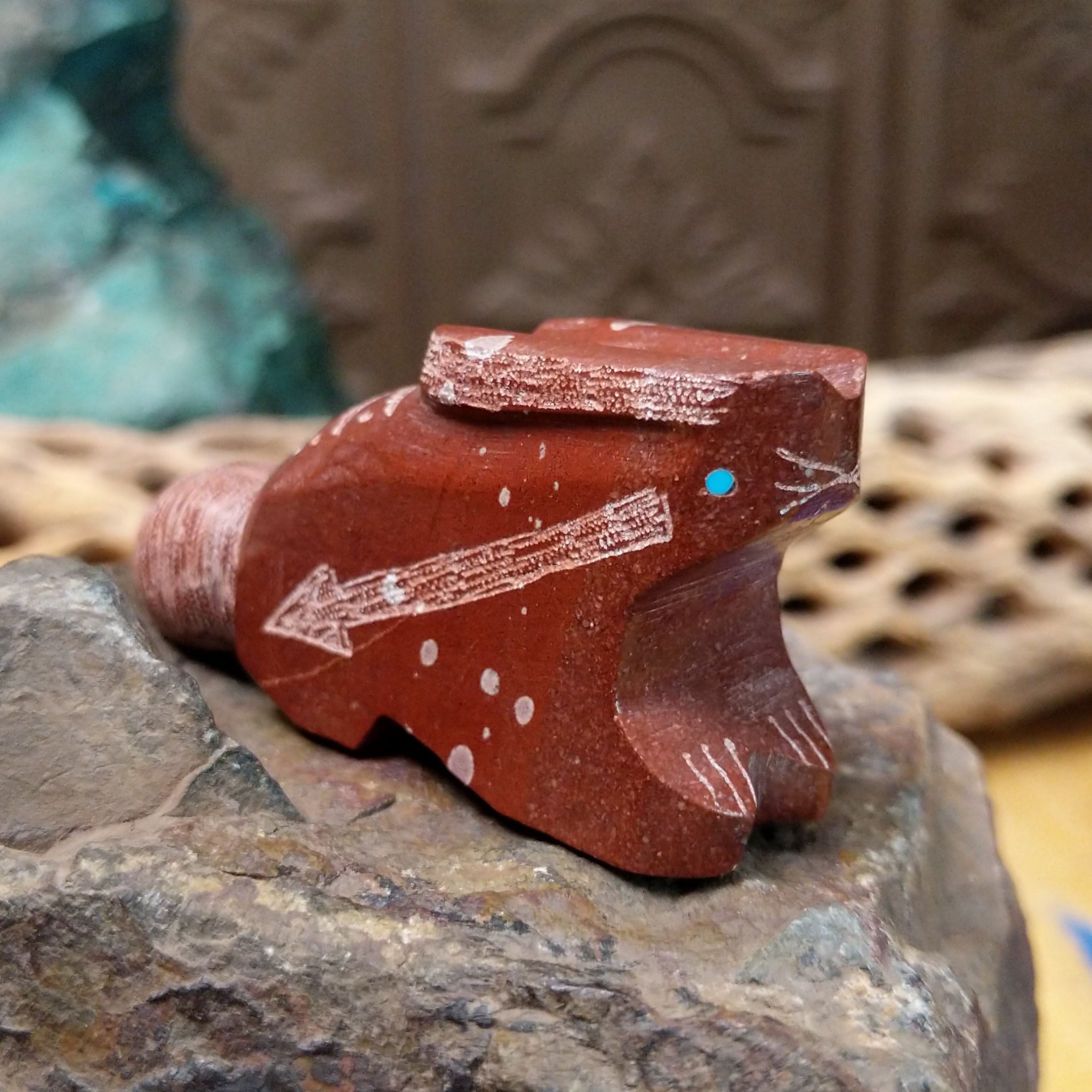 Rabbit Zuni fetish carving by Patrick Wallace in red stone with an engraved arrow motif and turquoise inlaid eye.