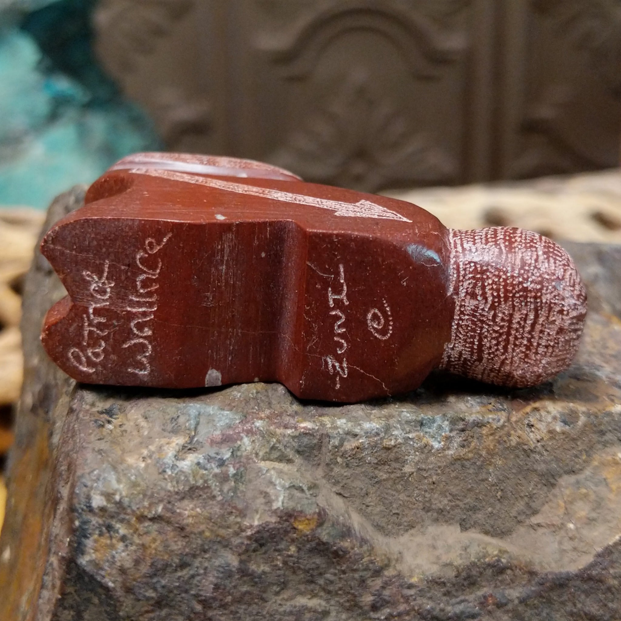 Close up of the artist's etched signature.
