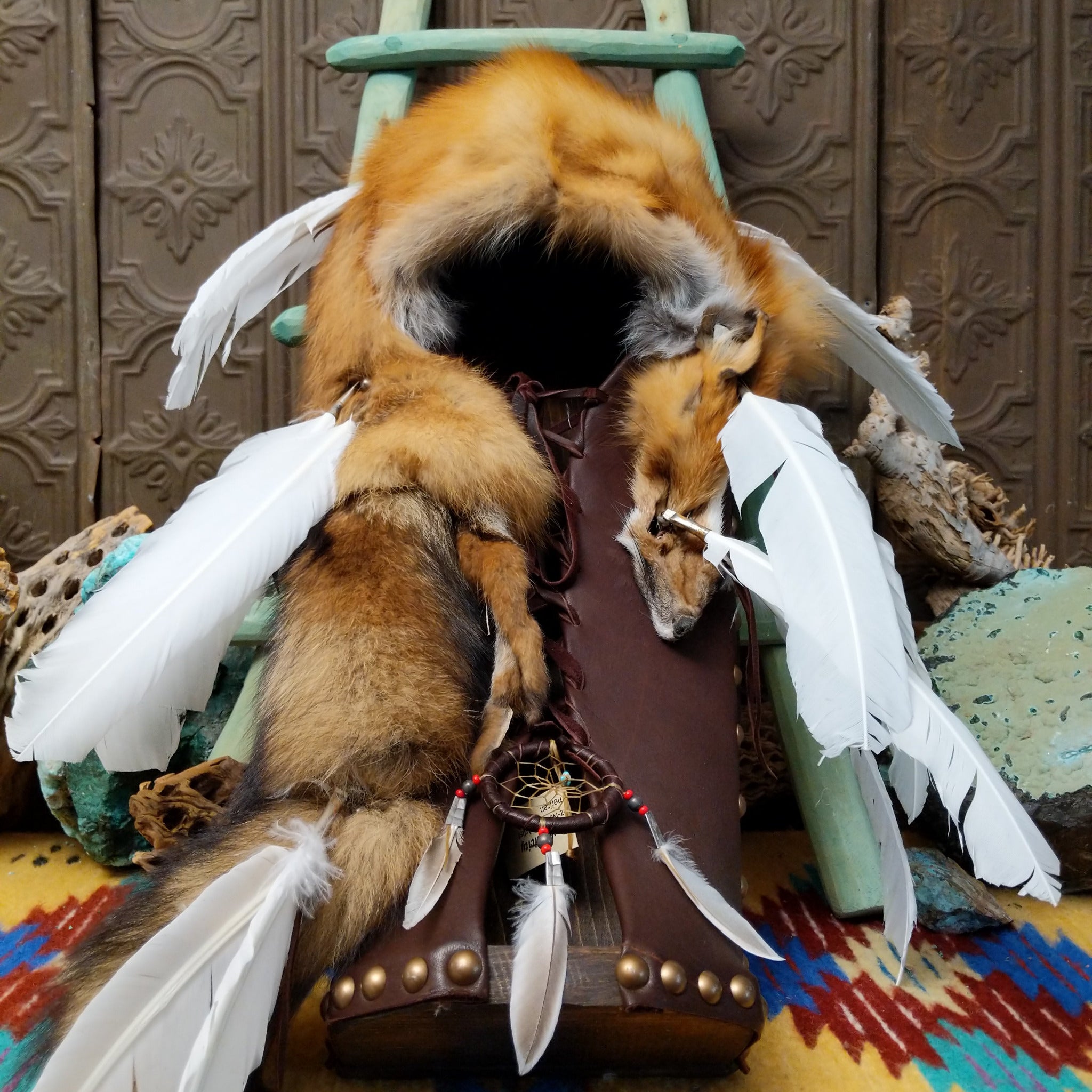 Red Fox Cradleboard artifact reproduction by Lyrissa Lee Chavez-Nelson featuring a red fox pelt, leather backing, and white feather accents.