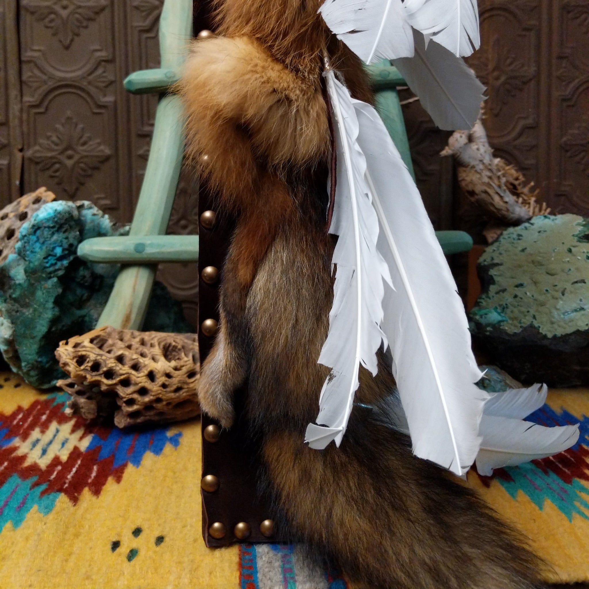 Red Fox Cradleboard artifact reproduction by Lyrissa Lee Chavez-Nelson featuring a red fox pelt, leather backing, and white feather accents.