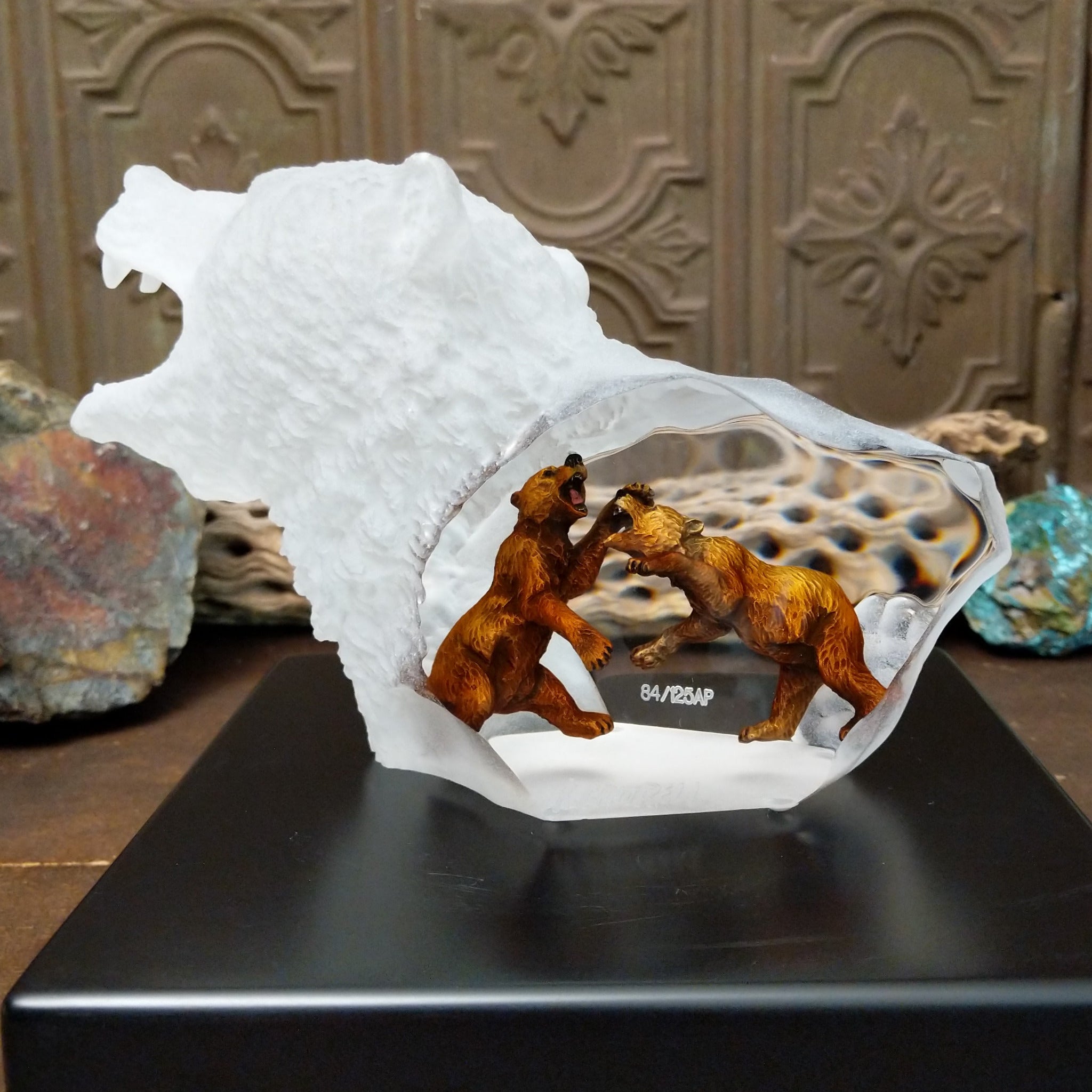 A frosted Lucite sculpture of a roaring grizzly bear with two hand-painted grizzly bears facing off inside the clear crystal interior.