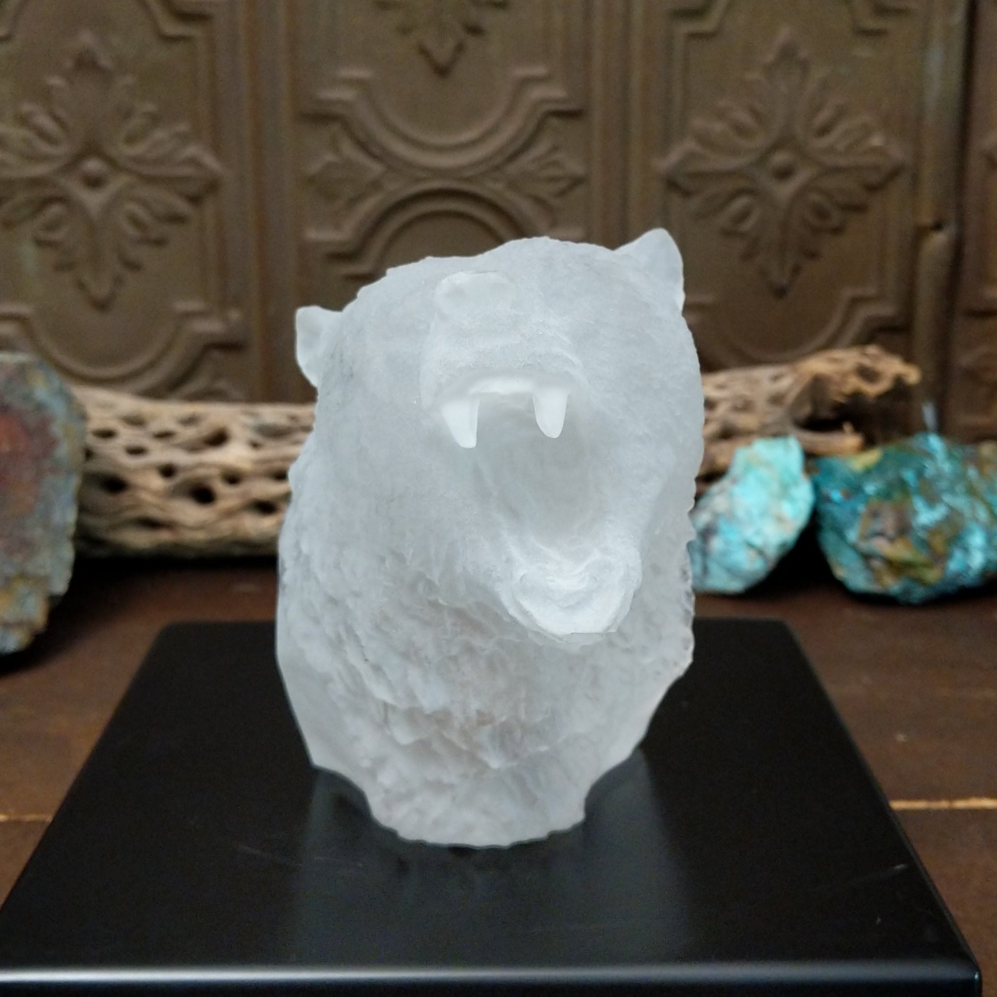 A frosted Lucite sculpture of a roaring grizzly bear with two hand-painted grizzly bears facing off inside the clear crystal interior.