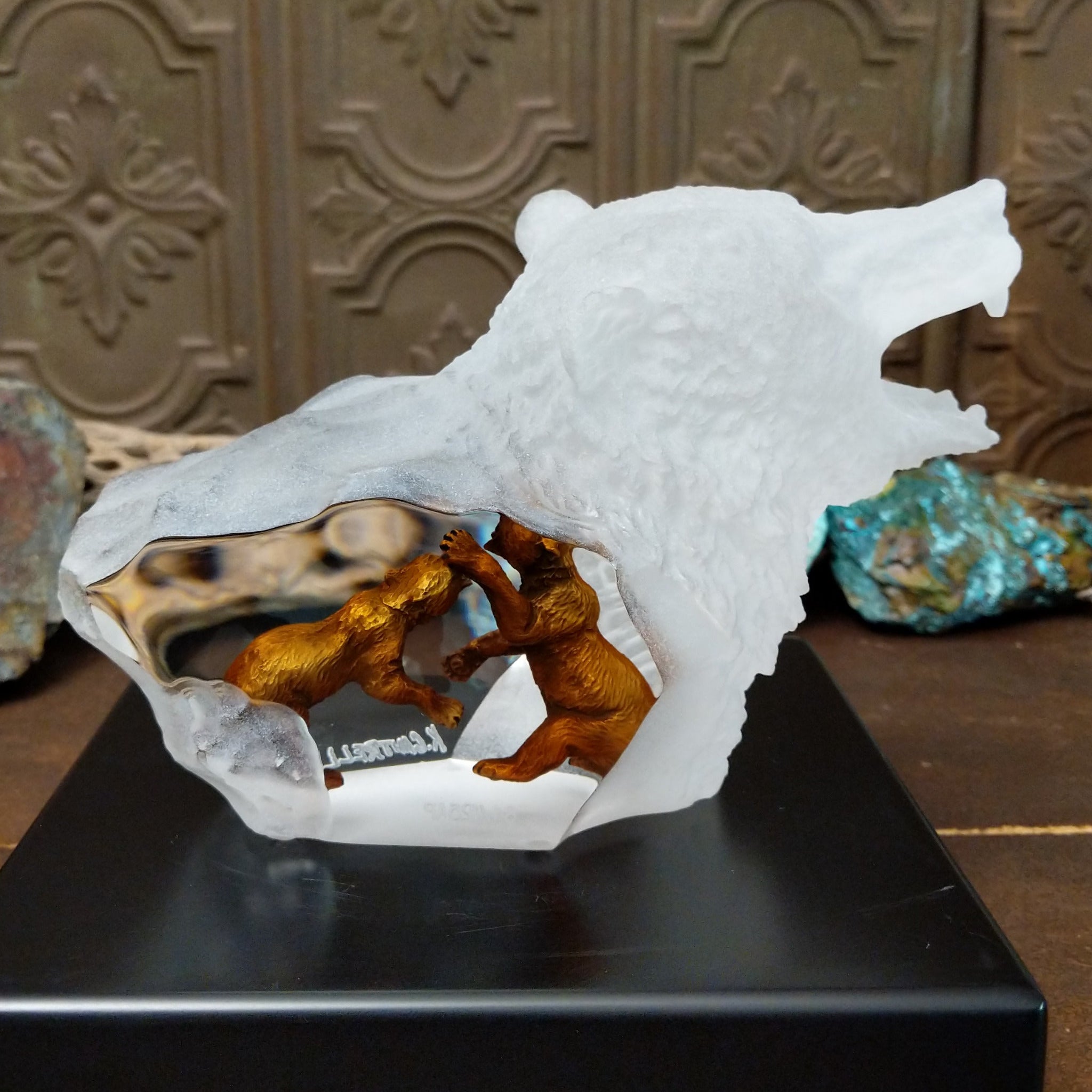 A frosted Lucite sculpture of a roaring grizzly bear with two hand-painted grizzly bears facing off inside the clear crystal interior.