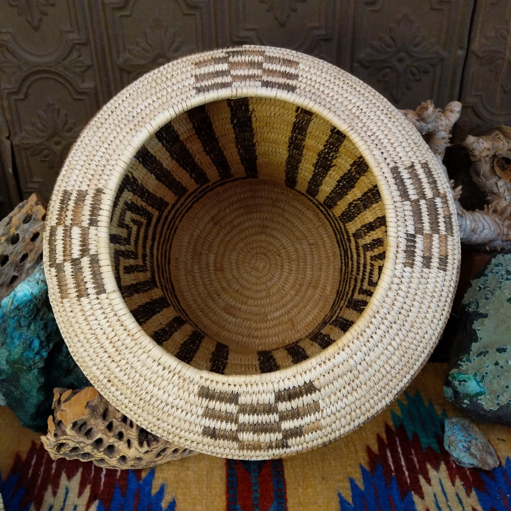Award-winning Tohono O'odham handwoven lidded basket by Mary Thomas with geometric woven patterns in natural and dark fibers.