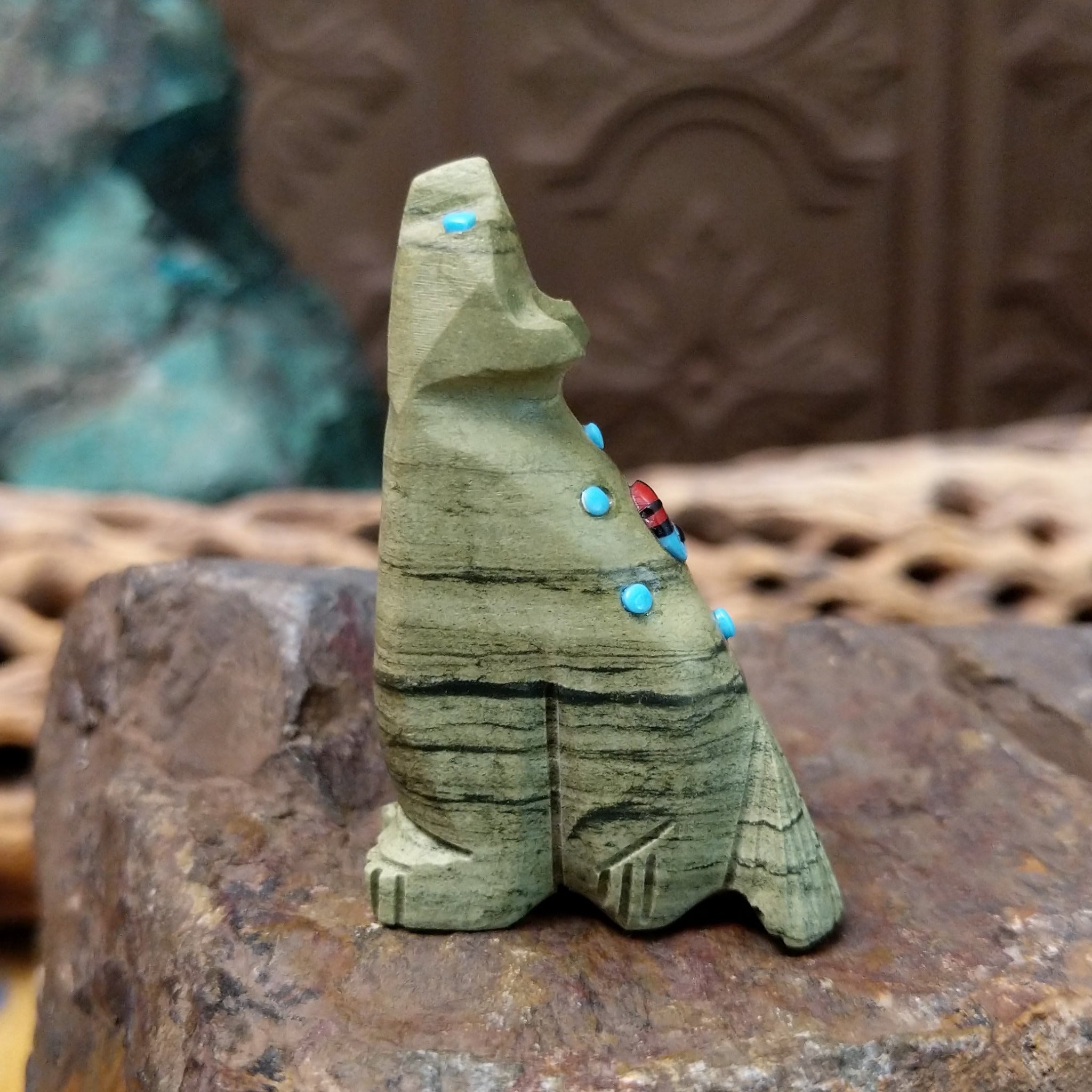 Wolf Zuni fetish carving by Danette Laate in green serpentine with turquoise inlay and a colorful medicine bundle.