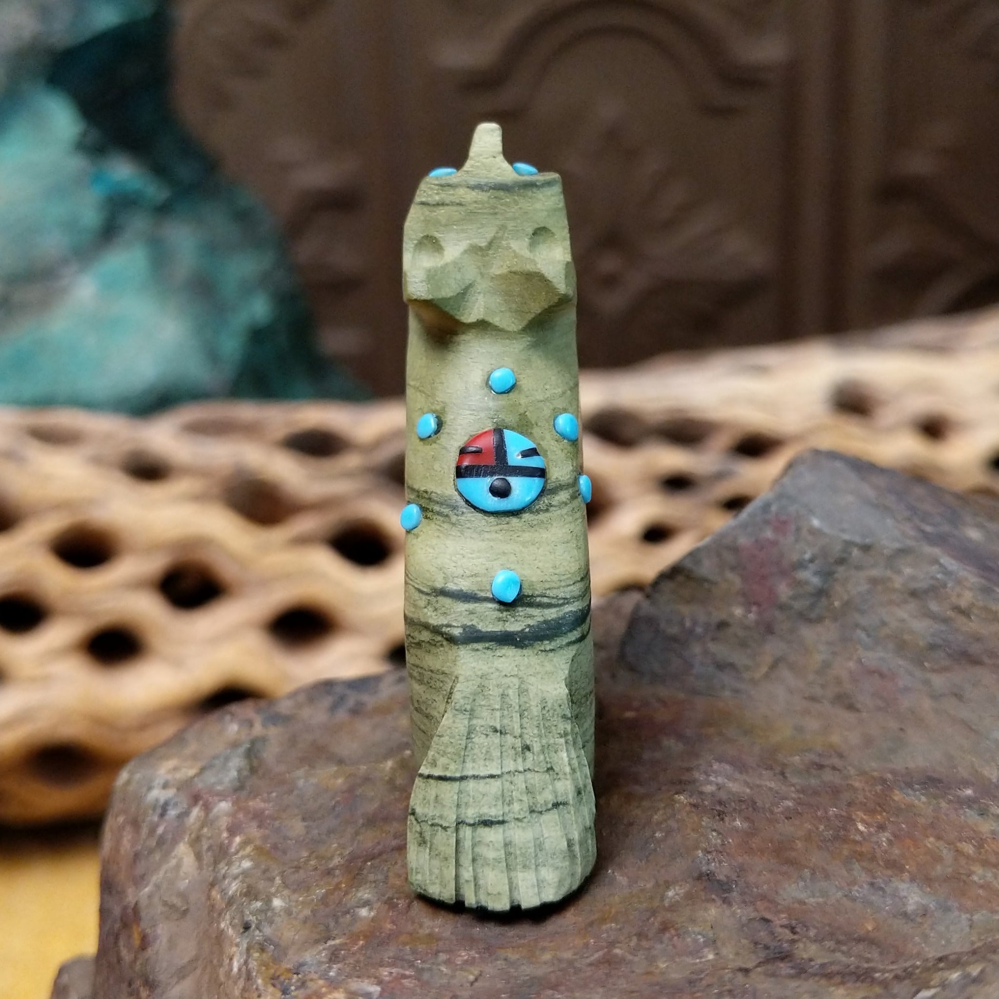 Wolf Zuni fetish carving by Danette Laate in green serpentine with turquoise inlay and a colorful medicine bundle.