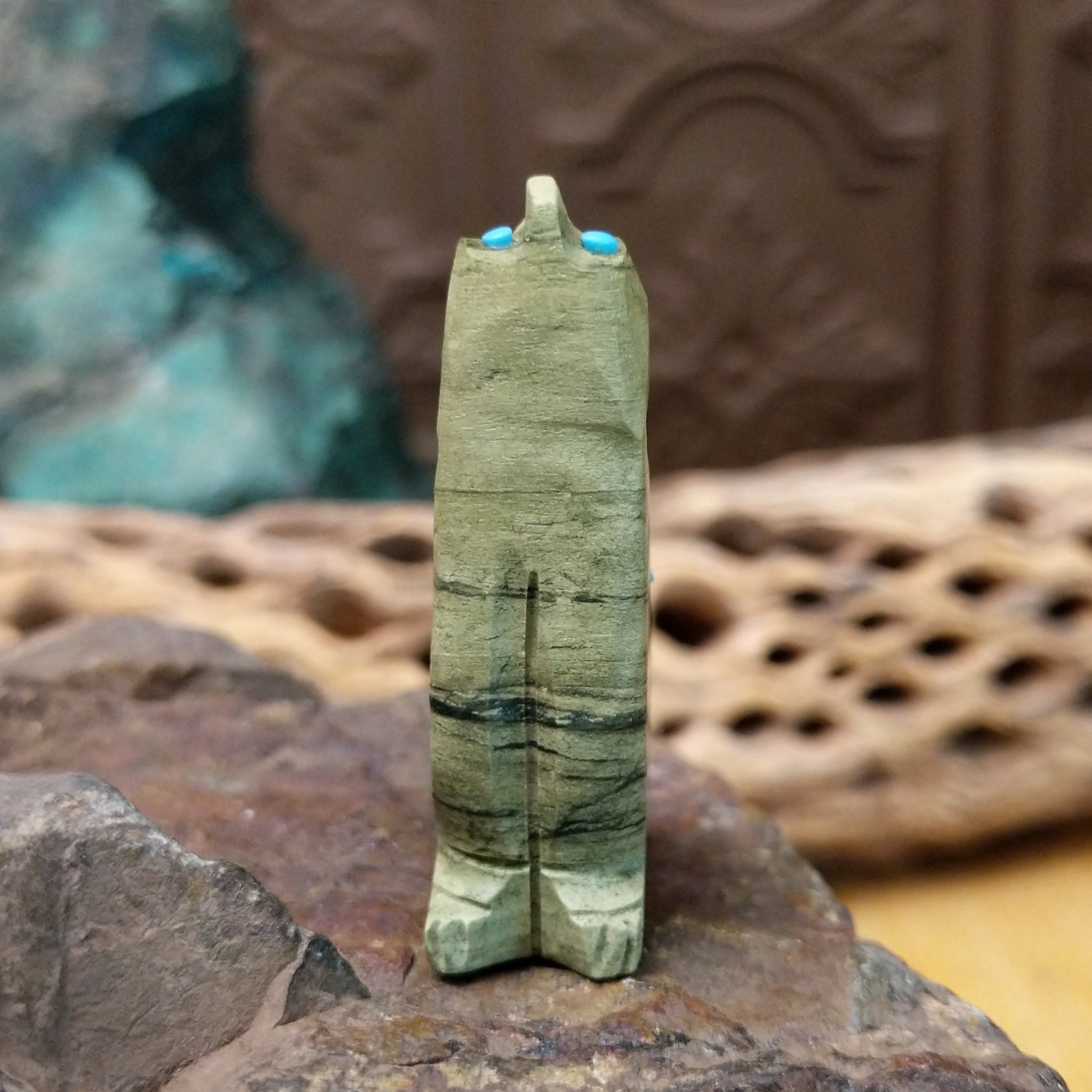 Wolf Zuni fetish carving by Danette Laate in green serpentine with turquoise inlay and a colorful medicine bundle.